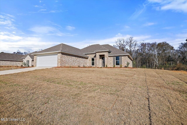 view of front of property with a garage and a front yard