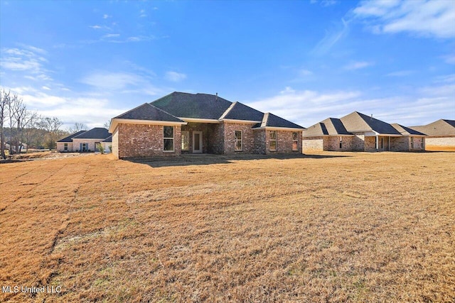 rear view of property with a yard