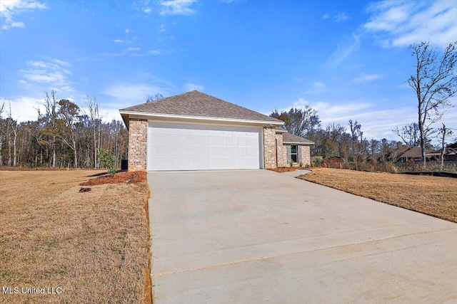 view of front of house featuring a garage and a front lawn