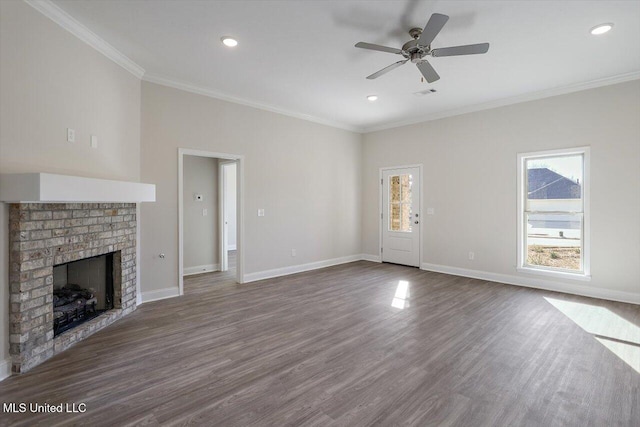 unfurnished living room featuring ornamental molding, a brick fireplace, hardwood / wood-style floors, and ceiling fan