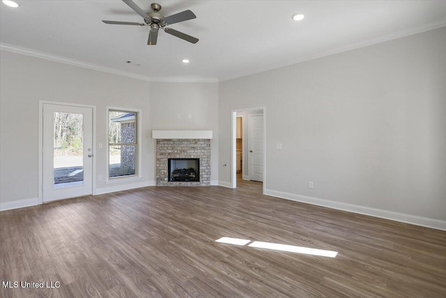 unfurnished living room featuring hardwood / wood-style flooring, ornamental molding, and ceiling fan