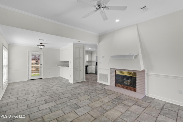 unfurnished living room with a fireplace, visible vents, and crown molding