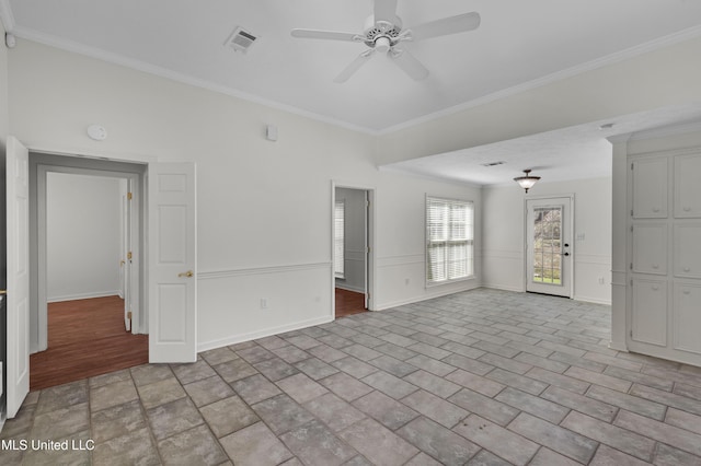 unfurnished living room featuring ceiling fan, visible vents, crown molding, and wainscoting