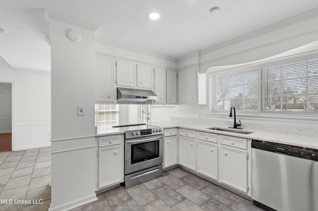 kitchen featuring stainless steel appliances, white cabinetry, a sink, light stone countertops, and under cabinet range hood