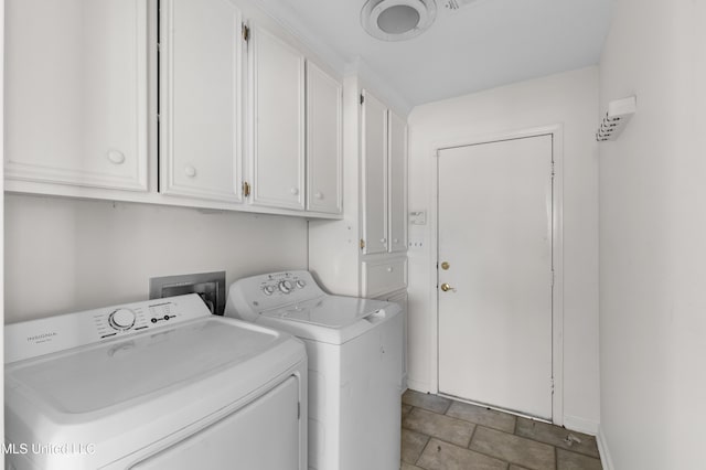 laundry room with separate washer and dryer, cabinet space, and baseboards