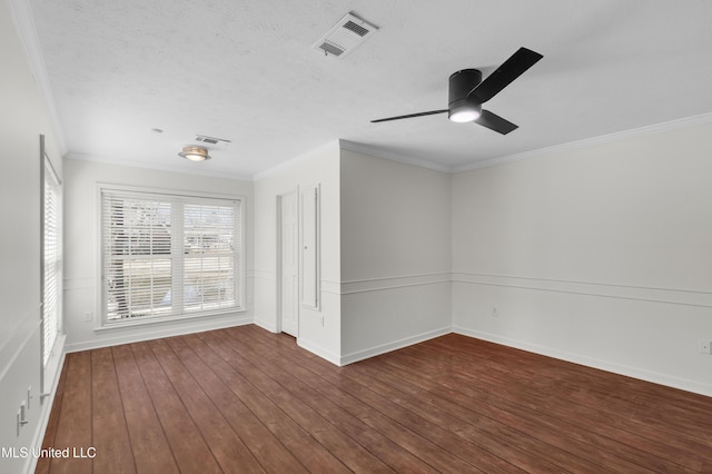 spare room featuring ornamental molding, visible vents, a textured ceiling, and hardwood / wood-style floors