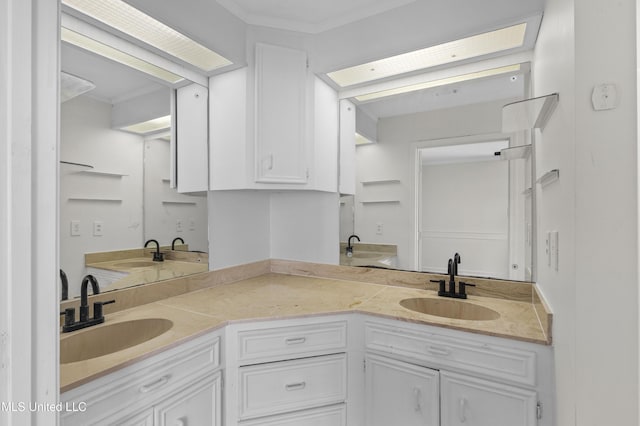 full bath with double vanity, ornamental molding, and a sink