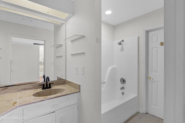 bathroom featuring tile patterned flooring, shower / bath combination, and vanity