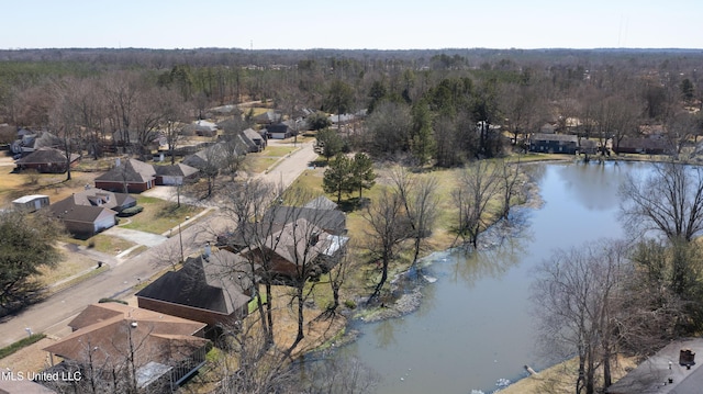 drone / aerial view with a water view and a wooded view