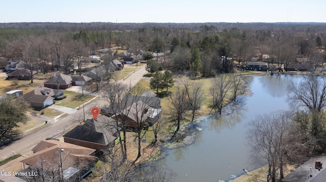 drone / aerial view featuring a forest view and a water view