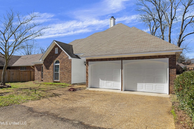 view of front of property featuring an attached garage, brick siding, fence, concrete driveway, and a chimney