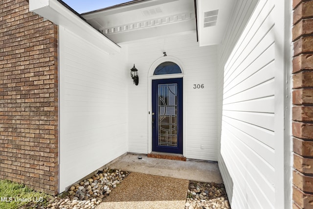 property entrance with brick siding