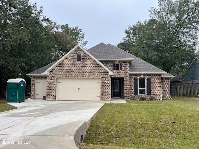 view of front of house featuring a garage and a front yard