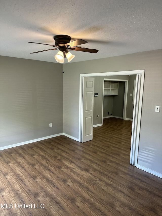 203 Barrow St, Pearl, MS 39208 - empty room with a ceiling fan, dark wood-style flooring, baseboards, and a textured ceiling