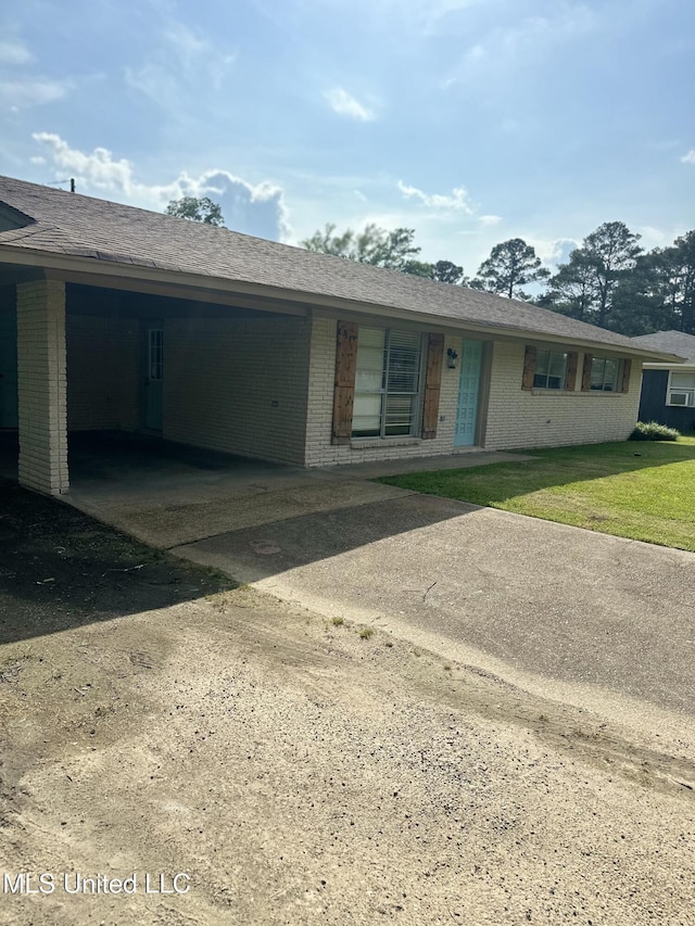 203 Barrow St, Pearl, MS 39208 - ranch-style house featuring brick siding, concrete driveway, a carport, and a front yard