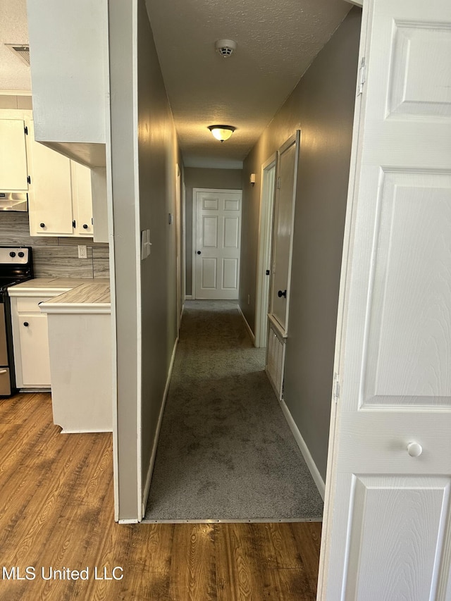 203 Barrow St, Pearl, MS 39208 - hallway featuring dark wood finished floors, baseboards, and a textured ceiling