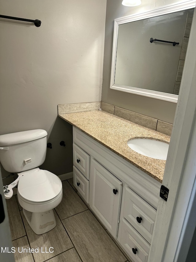 203 Barrow St, Pearl, MS 39208 - half bathroom featuring vanity, toilet, baseboards, and tile patterned floors