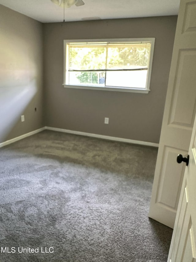 203 Barrow St, Pearl, MS 39208 - empty room with dark carpet, baseboards, and ceiling fan