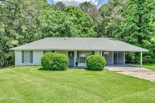 ranch-style home with driveway, an attached carport, a front lawn, and roof with shingles