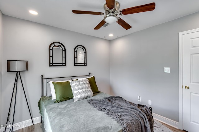 bedroom featuring baseboards, wood finished floors, a ceiling fan, and recessed lighting