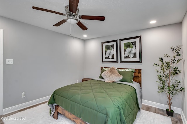 bedroom with wood finished floors, baseboards, ceiling fan, and recessed lighting