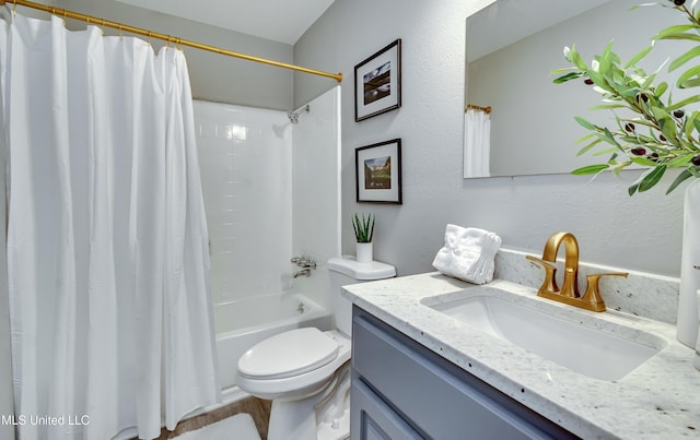 full bath with toilet, vanity, shower / bath combination with curtain, and a textured wall