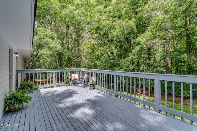 wooden deck featuring a wooded view