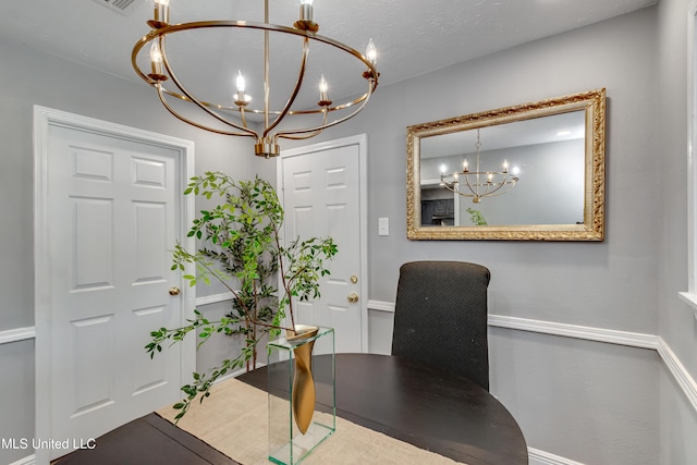 home office with a chandelier and baseboards