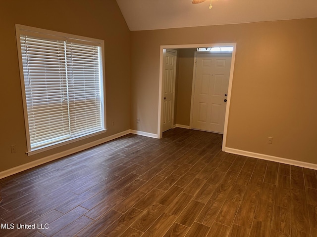 7807 S Chesterfield Dr, Southaven, MS 38671 - unfurnished room featuring dark wood-style floors, lofted ceiling, baseboards, and healthy amount of natural light