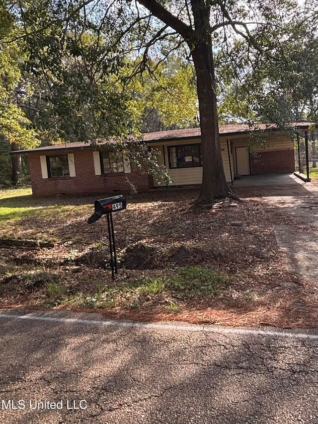 single story home featuring a carport