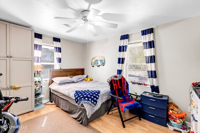 bedroom with a ceiling fan and wood finished floors