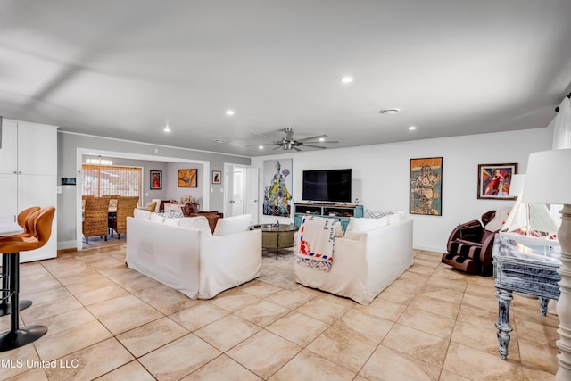 living area with light tile patterned floors, baseboards, a ceiling fan, and recessed lighting