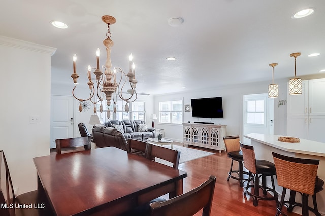 dining room featuring ornamental molding, a chandelier, and dark hardwood / wood-style floors