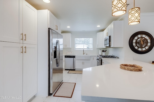 kitchen featuring white cabinets, sink, stainless steel appliances, and pendant lighting