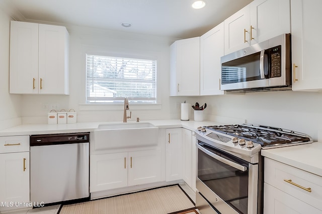 kitchen with sink, stainless steel appliances, and white cabinetry