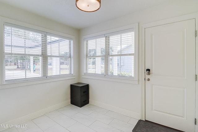 doorway to outside with light tile patterned floors