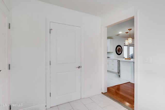 corridor with light tile patterned floors and wine cooler