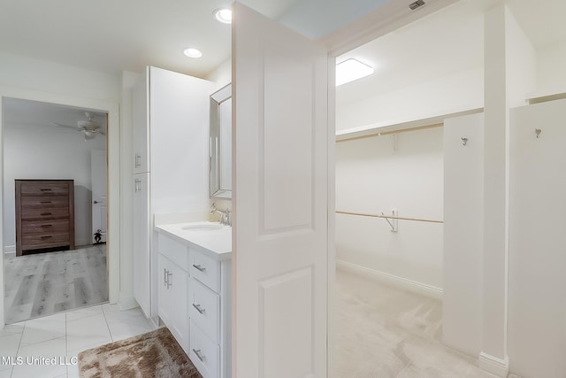 bathroom featuring ceiling fan and vanity