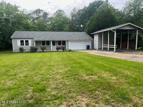 single story home with a garage, a front lawn, and an outbuilding