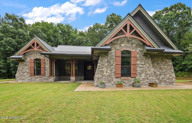 4676 W Star Landing Rd, Nesbit, MS 38651 - view of front of property with stone siding, a front yard, metal roof, and a standing seam roof