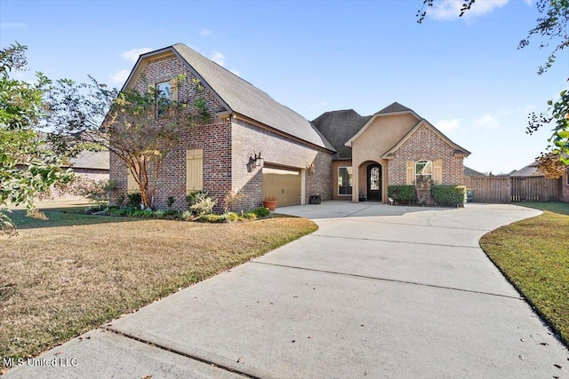 french provincial home featuring a front lawn and a garage