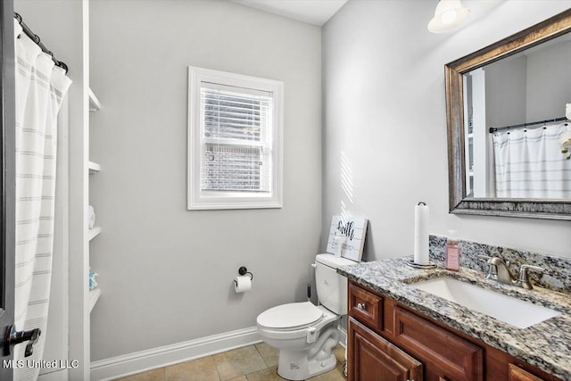 bathroom featuring vanity, tile patterned floors, and toilet