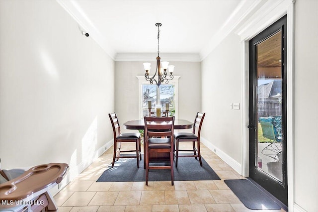 dining area with ornamental molding, a notable chandelier, and light tile patterned floors