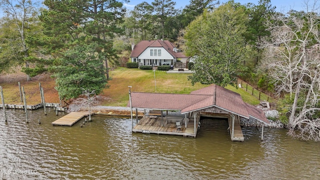 dock area featuring a lawn and a water view