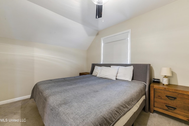 bedroom featuring lofted ceiling, ceiling fan, and light carpet