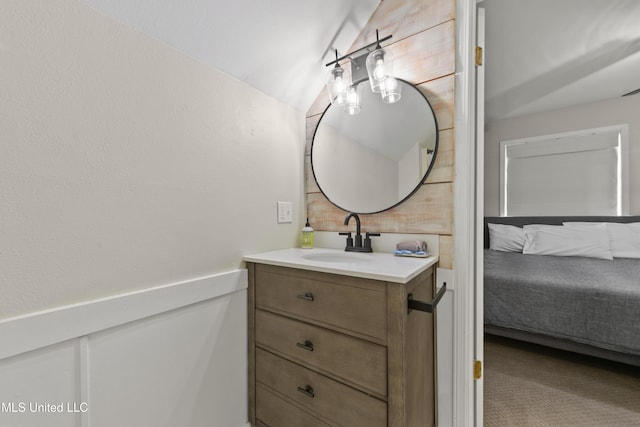 bathroom featuring lofted ceiling and vanity