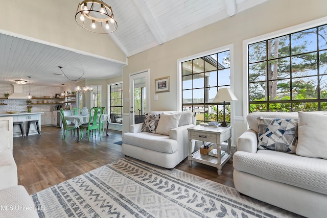 living room featuring dark hardwood / wood-style flooring, high vaulted ceiling, an inviting chandelier, and beamed ceiling