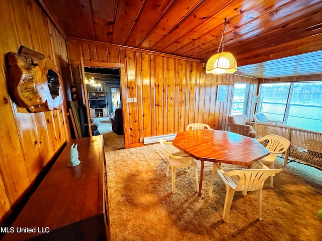 dining space with wood ceiling, carpet, wooden walls, and a baseboard heating unit