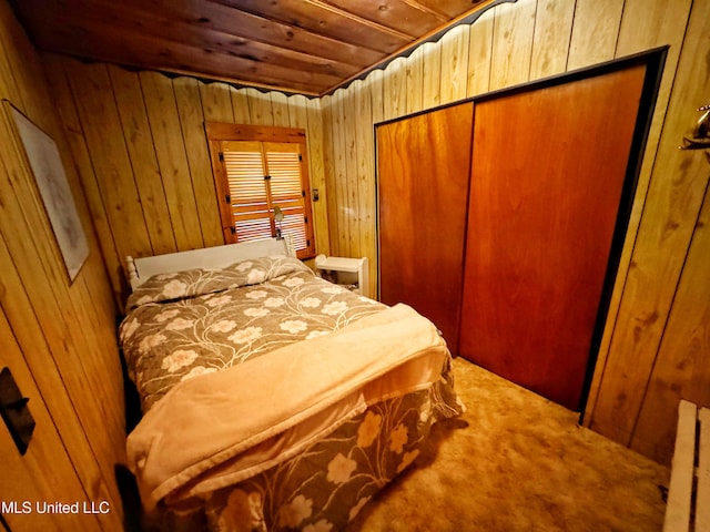 bedroom featuring wooden walls, wood ceiling, and carpet flooring