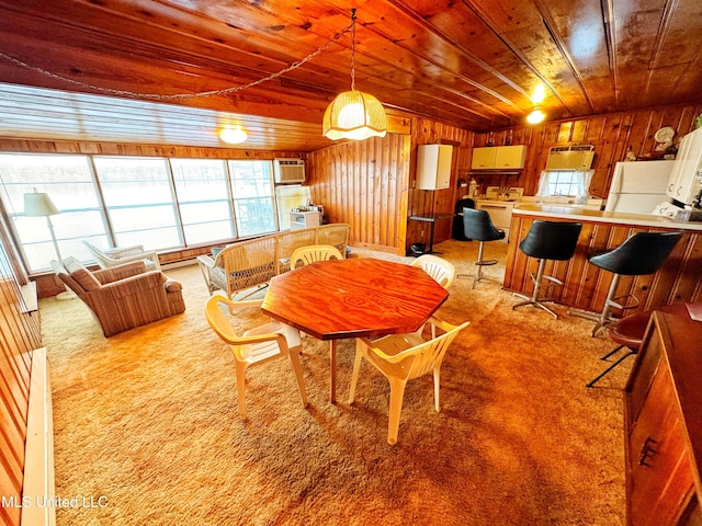 carpeted dining room with a wall unit AC, wooden walls, and wooden ceiling
